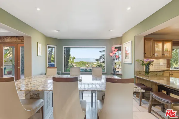 a very nice looking dining room with kitchen island furniture and a large window