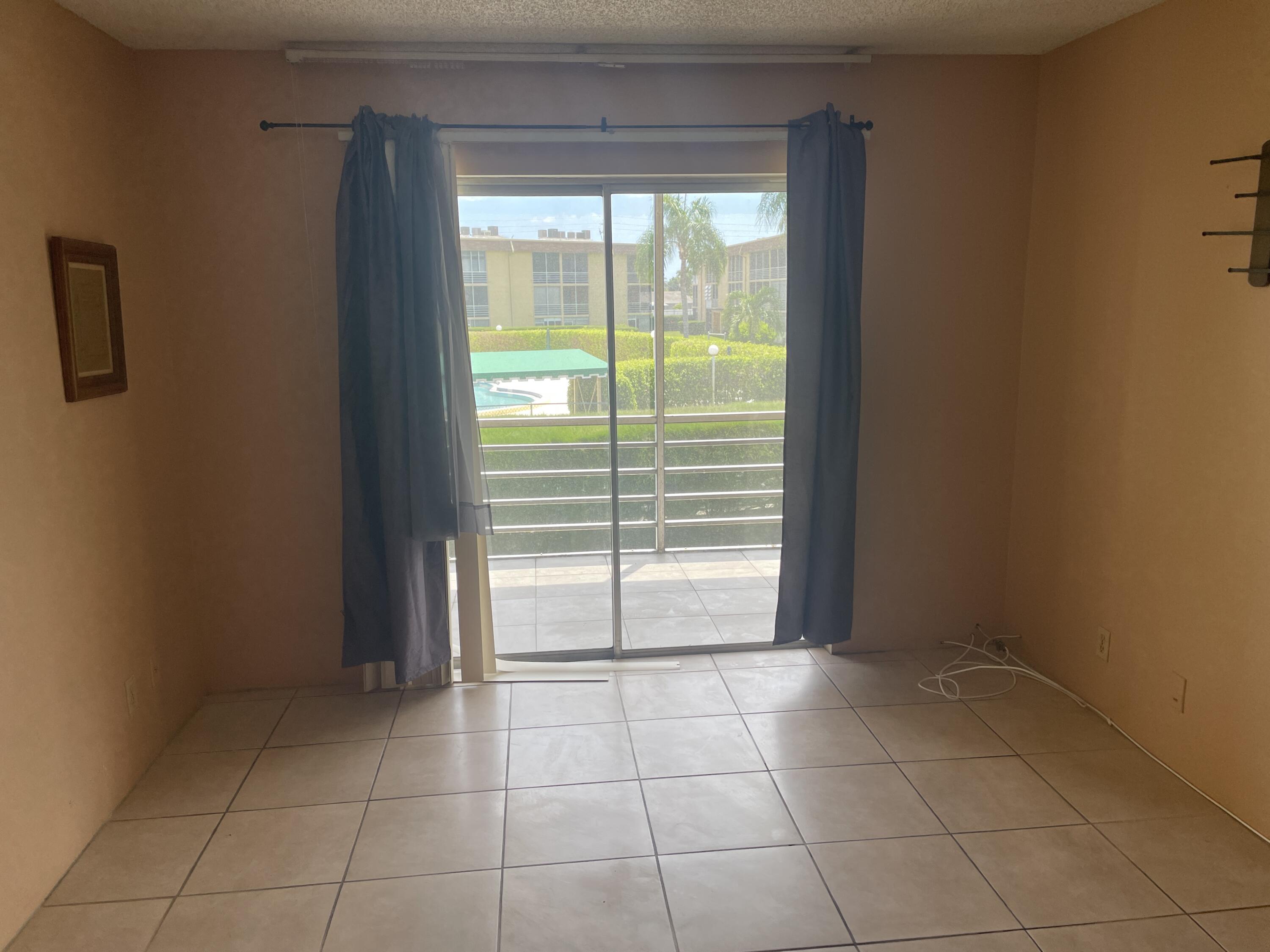 500 Village Green Circle West, Unit 212 Palm Springs, FL 33461 - Photo 11 of 23 a view of an empty room and window