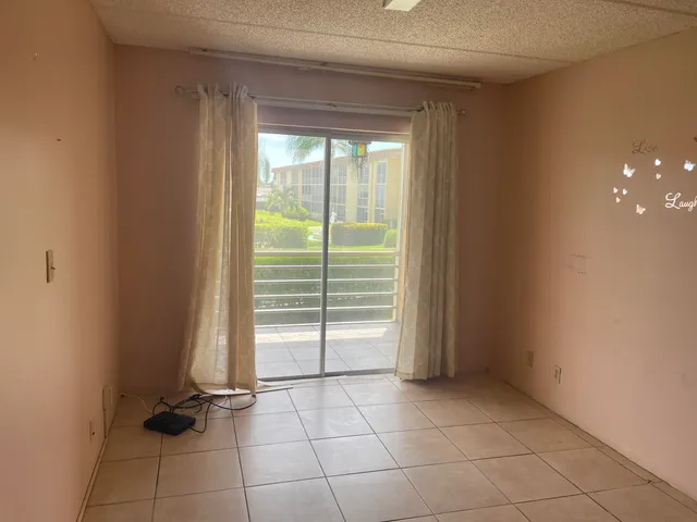 a bathroom with a granite countertop toilet sink and mirror
