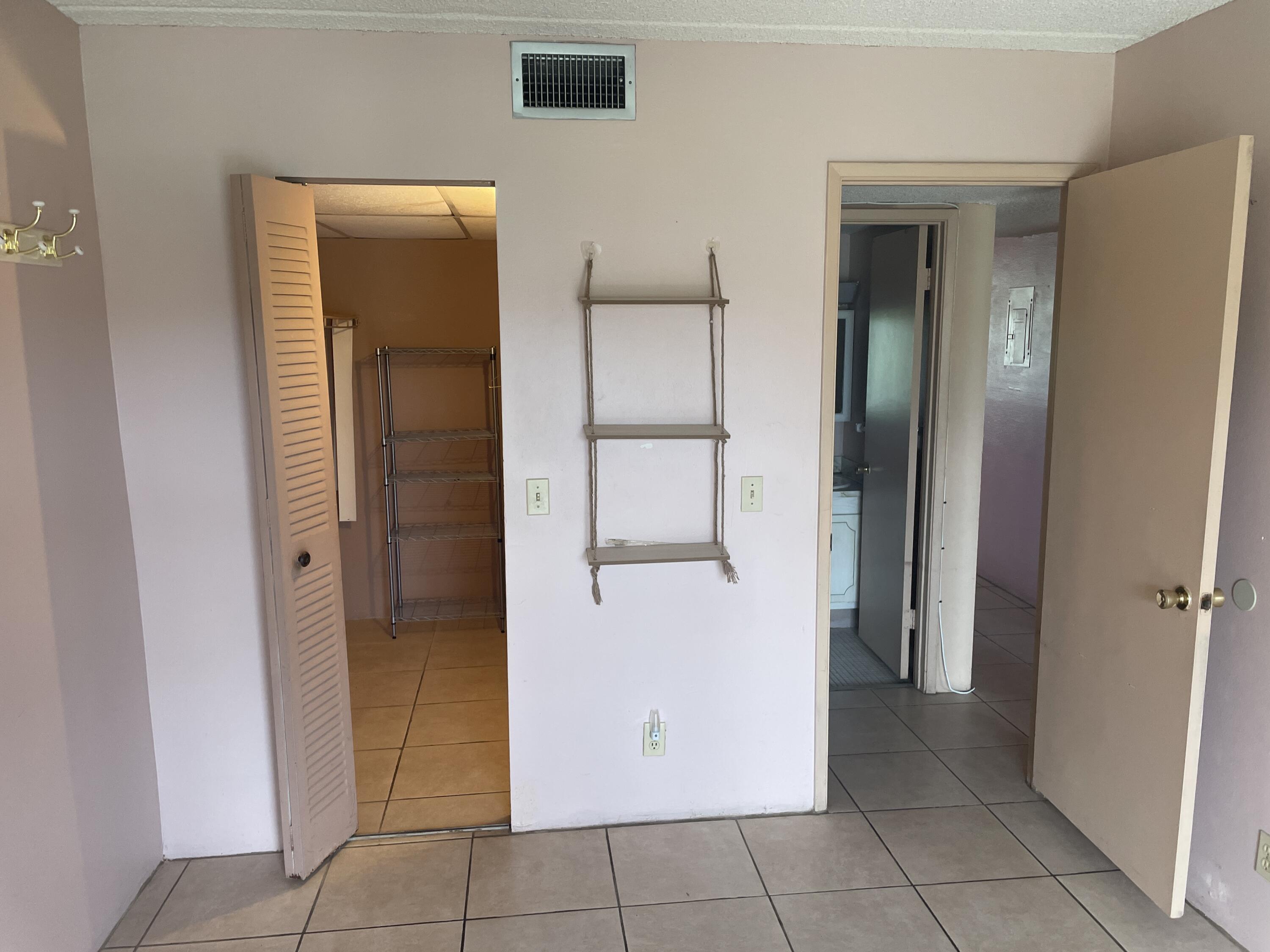 500 Village Green Circle West, Unit 212 Palm Springs, FL 33461 - Photo 13 of 23 wooden floor in an empty room