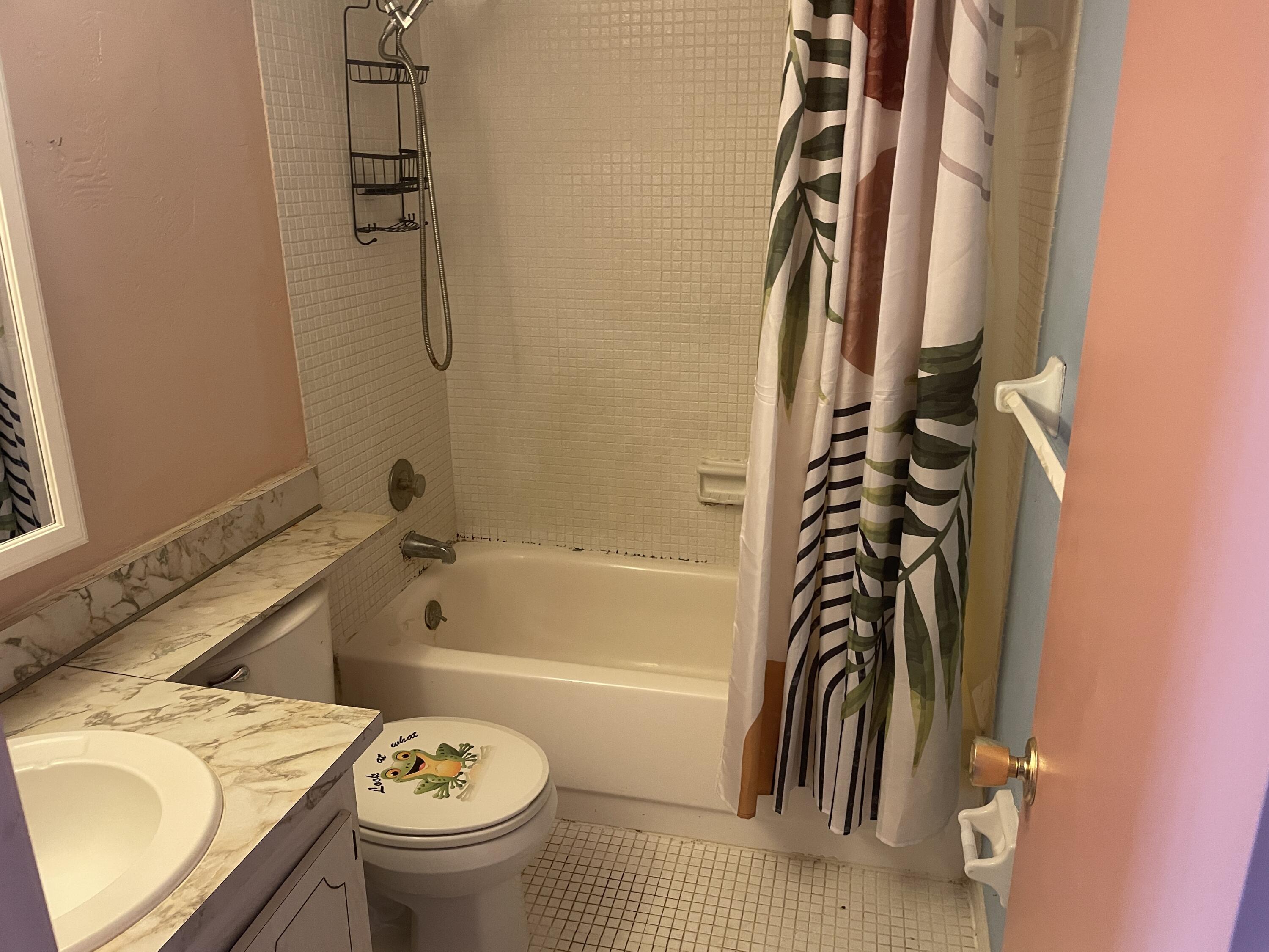 500 Village Green Circle West, Unit 212 Palm Springs, FL 33461 - Photo 16 of 23 a bathroom with a sink a toilet and a bathtub