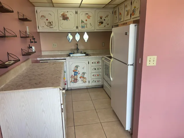 a view of a refrigerator and cabinets