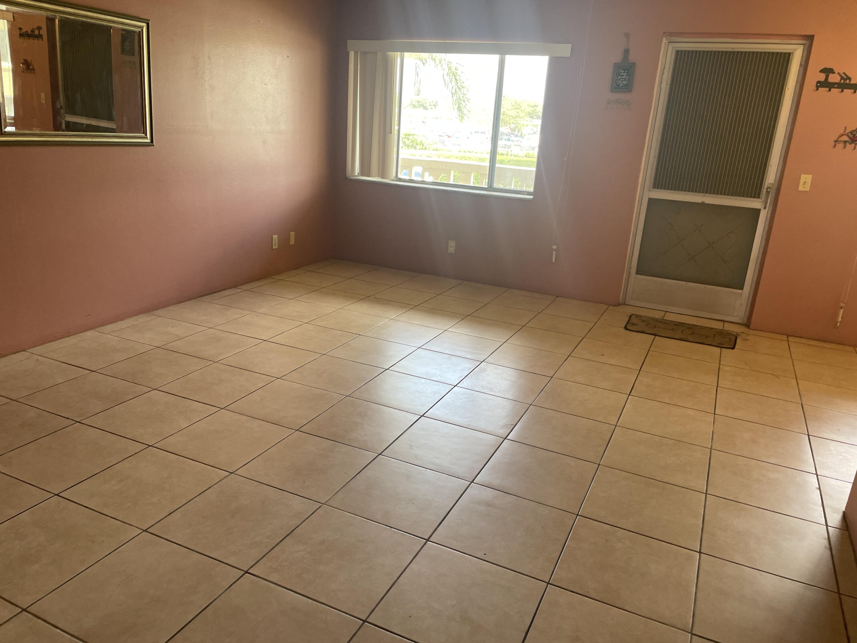 500 Village Green Circle West, Unit 212 Palm Springs, FL 33461 - Photo 5 of 23 a view of an empty room with a window