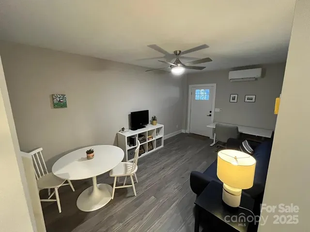 a kitchen with granite countertop white cabinets and a stove