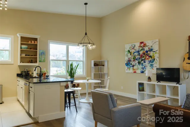 a living room with furniture a flat screen tv and a window