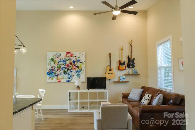 a living room with furniture and wooden floor