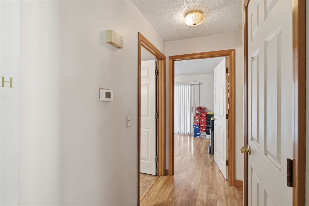 222 Edendale Street Springfield, MA 01104 - Photo 16 of 36 a view of a hallway with wooden floor