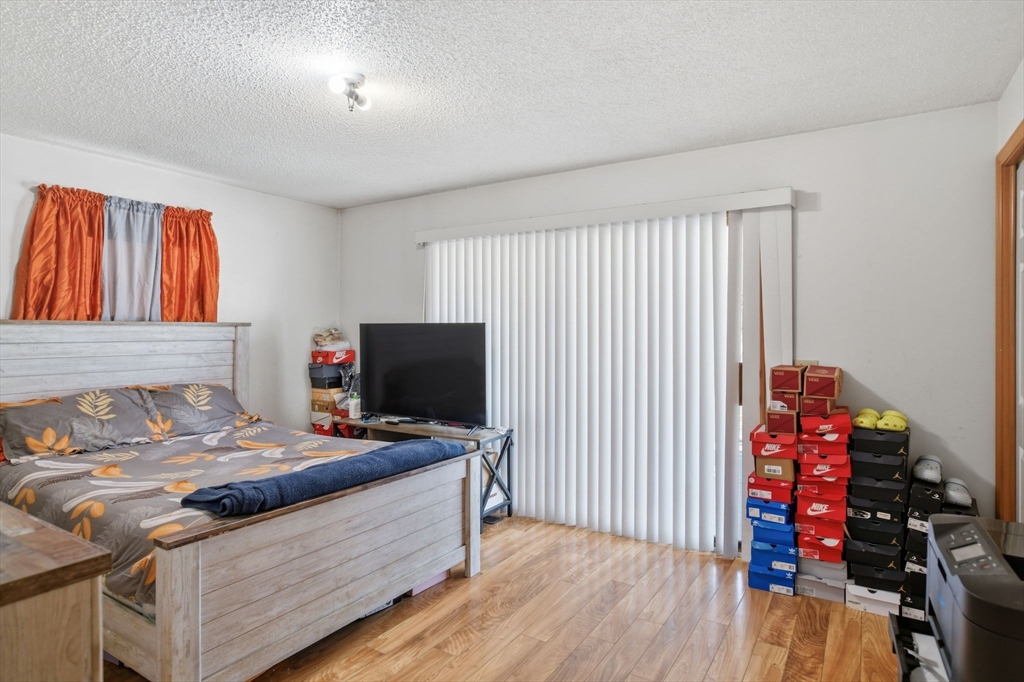 222 Edendale Street Springfield, MA 01104 - Photo 20 of 36 a bedroom with a bed and a flat screen tv