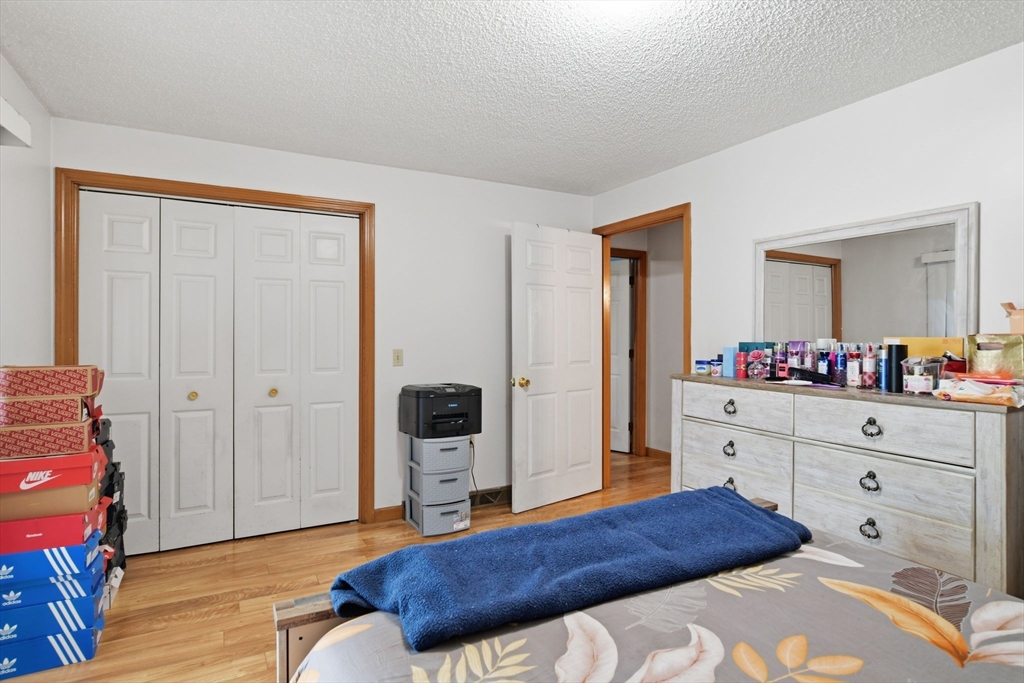 222 Edendale Street Springfield, MA 01104 - Photo 22 of 36 a spacious bedroom with a bed and a dresser in it
