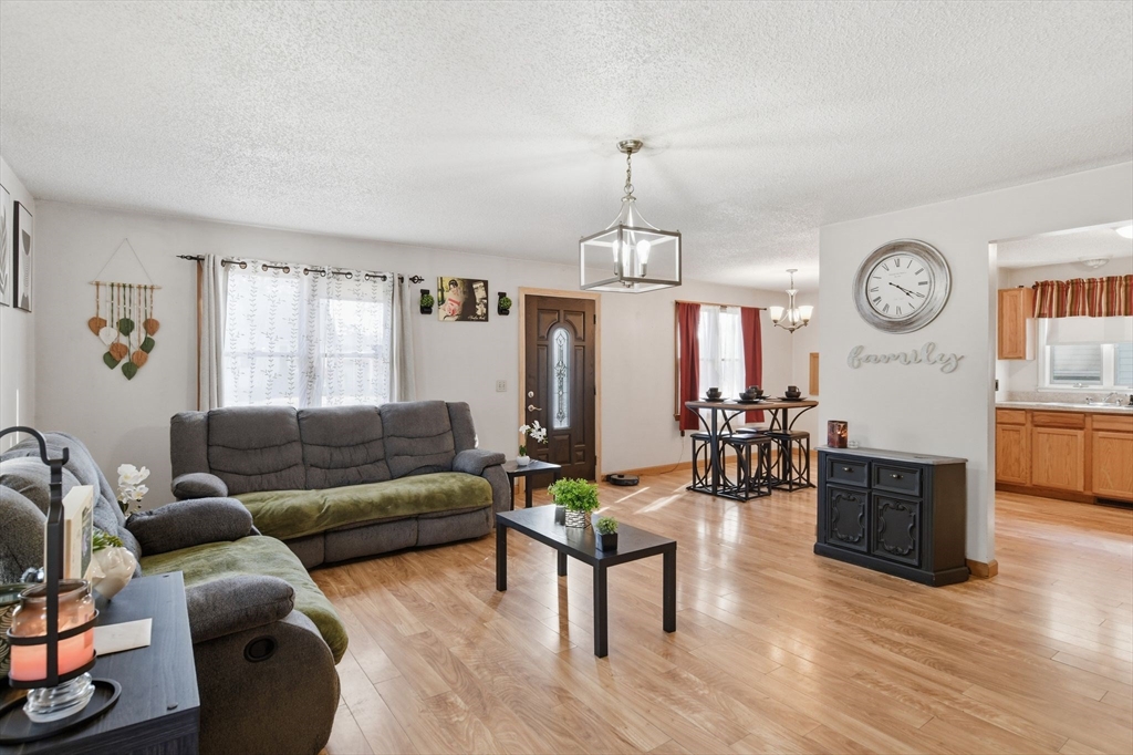 222 Edendale Street Springfield, MA 01104 - Photo 5 of 36 a living room with furniture kitchen view and a wooden floor