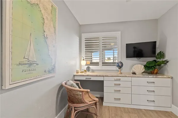 a room with a chair and a flat screen tv