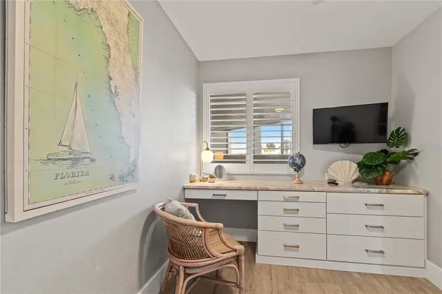 a room with a chair and a flat screen tv