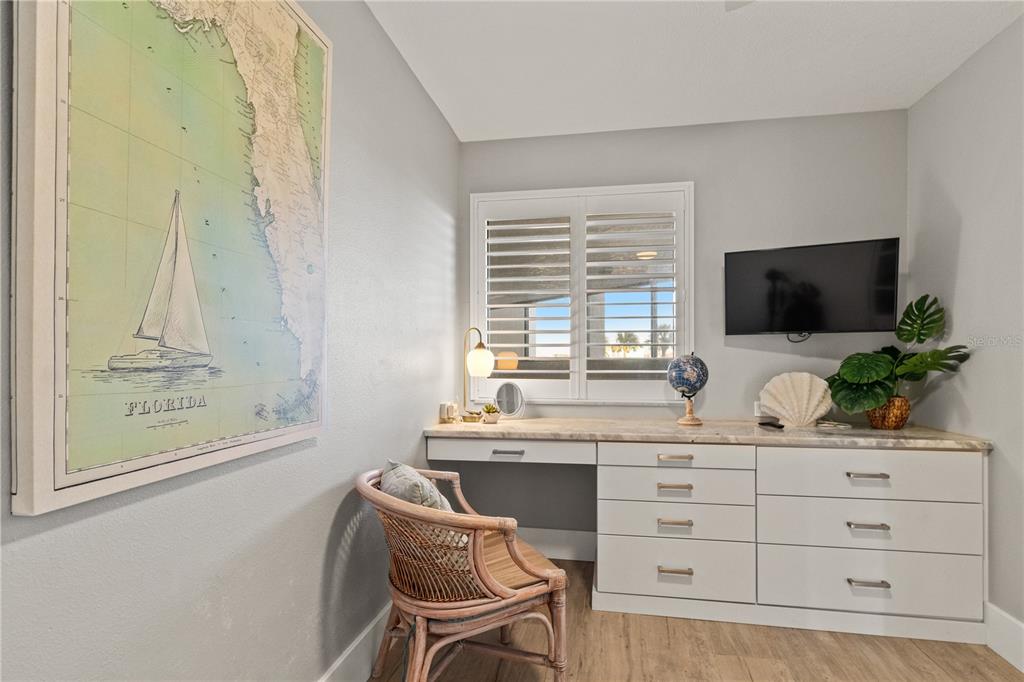 6035 Sea Ranch Drive, Unit 203 Hudson, FL 34667 - Photo 11 of 55 a room with a chair and a flat screen tv