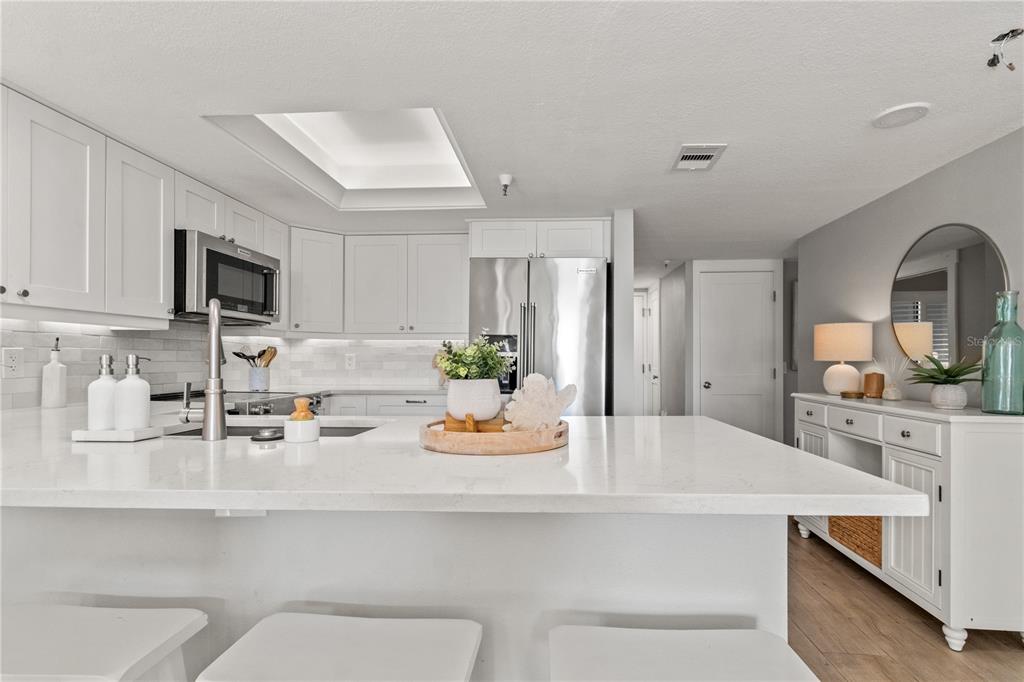 6035 Sea Ranch Drive, Unit 203 Hudson, FL 34667 - Photo 12 of 55 a kitchen with a sink a stove cabinets and counter space