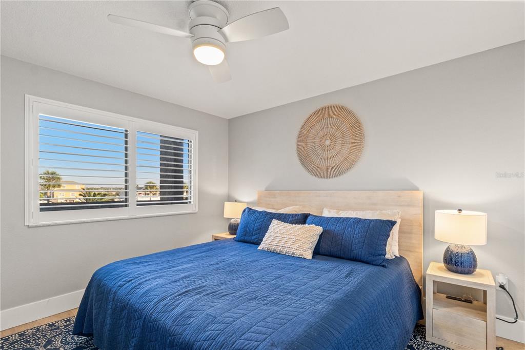 6035 Sea Ranch Drive, Unit 203 Hudson, FL 34667 - Photo 14 of 55 a bedroom with a bed and a window