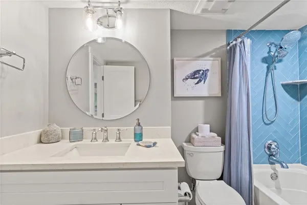 a bathroom with a sink a mirror a vanity and a shower