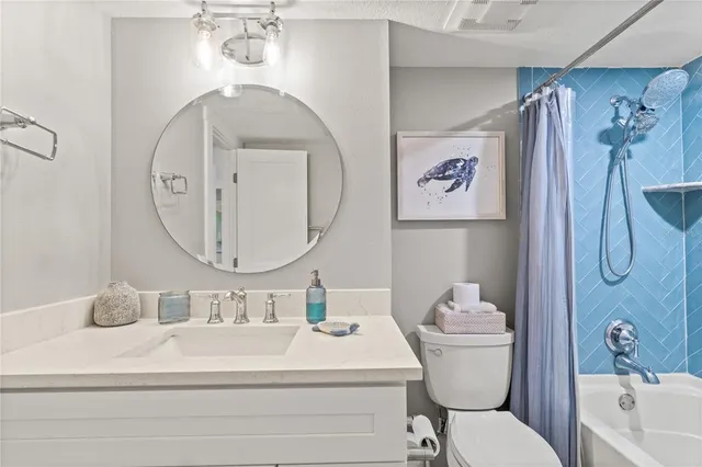 a bathroom with a sink a mirror a vanity and a shower
