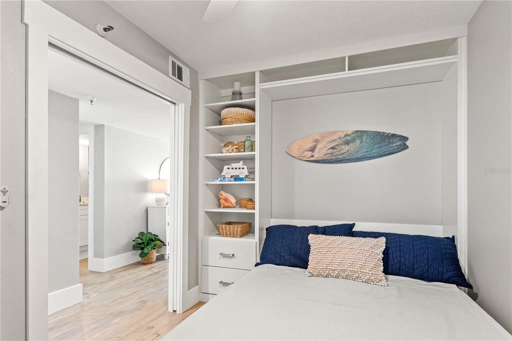 6035 Sea Ranch Drive, Unit 203 Hudson, FL 34667 - Photo 18 of 55 a bedroom with a bed and a table in it