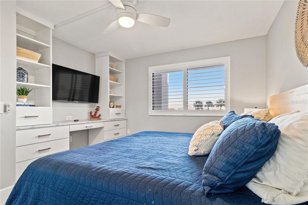 6035 Sea Ranch Drive, Unit 203 Hudson, FL 34667 - Photo 20 of 55 a spacious bedroom with a bed and a flat screen tv