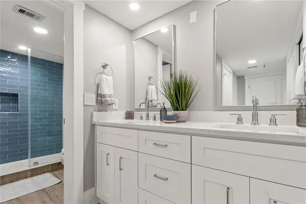 a large white bed sitting in a bedroom next to a window