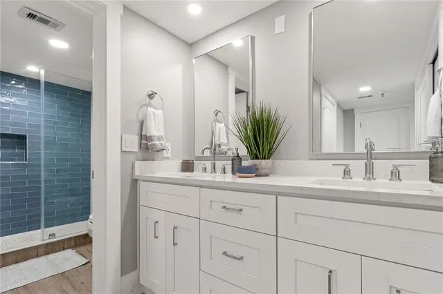 a large white bed sitting in a bedroom next to a window