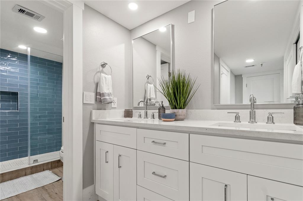 6035 Sea Ranch Drive, Unit 203 Hudson, FL 34667 - Photo 21 of 55 a bathroom with a double vanity sink and a mirror