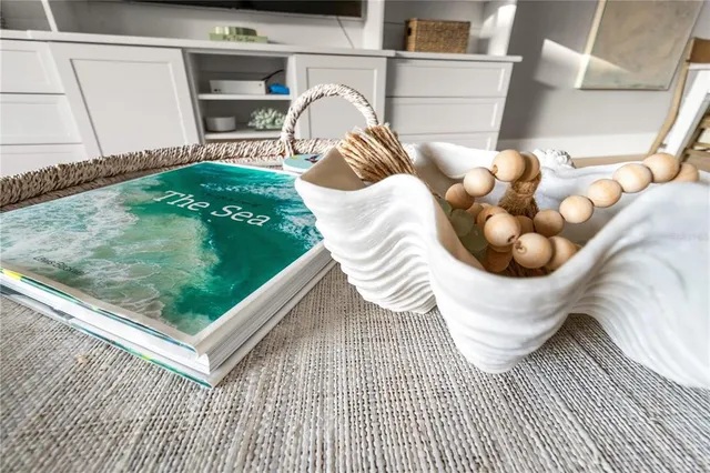 a closeup of a sink with a potted plant on kitchen counter top and stove