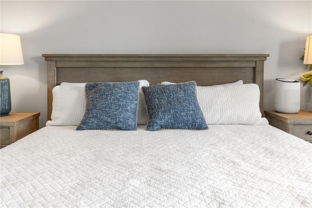 6035 Sea Ranch Drive, Unit 203 Hudson, FL 34667 - Photo 33 of 55 a bedroom with a bed and a night stand