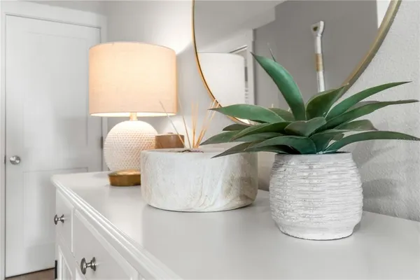 a table with a vase and window