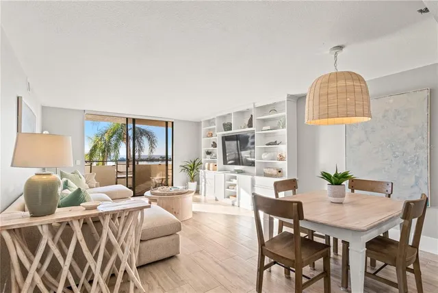 a living room with furniture a table and chairs