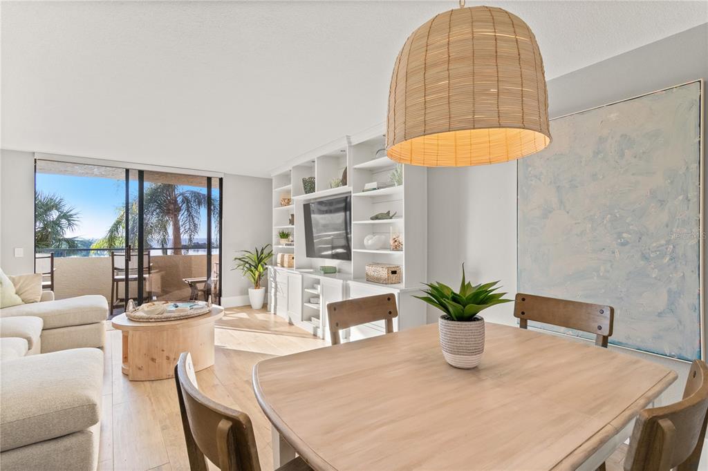 6035 Sea Ranch Drive, Unit 203 Hudson, FL 34667 - Photo 7 of 55 a dining room with table chairs and a potted plant