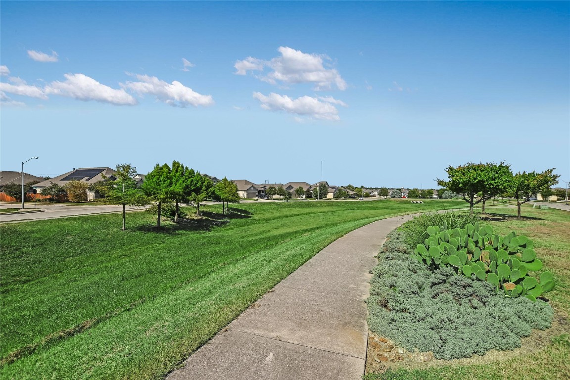 416 Cherokee Rose Circle Georgetown, TX 78626 - Photo 21 of 36 a view of a golf course with a lake