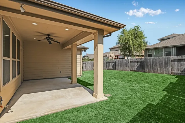 a view of a house with a yard and sitting area