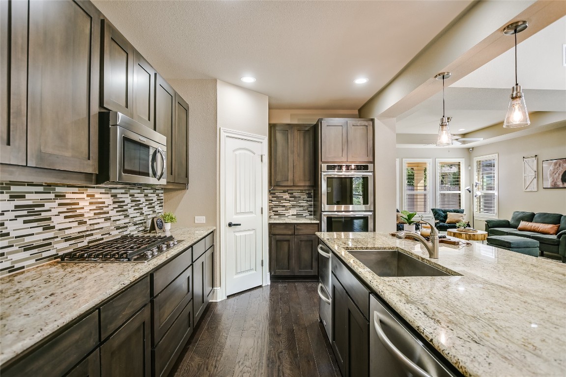 416 Cherokee Rose Circle Georgetown, TX 78626 - Photo 6 of 36 a kitchen with stainless steel appliances granite countertop a sink stove and refrigerator