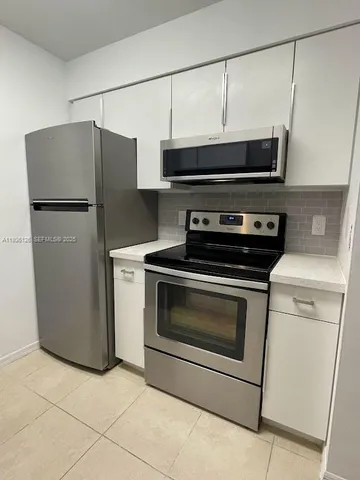 a kitchen with a stove and a microwave