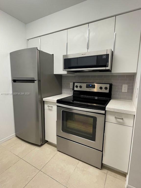 a kitchen with a stove and a microwave