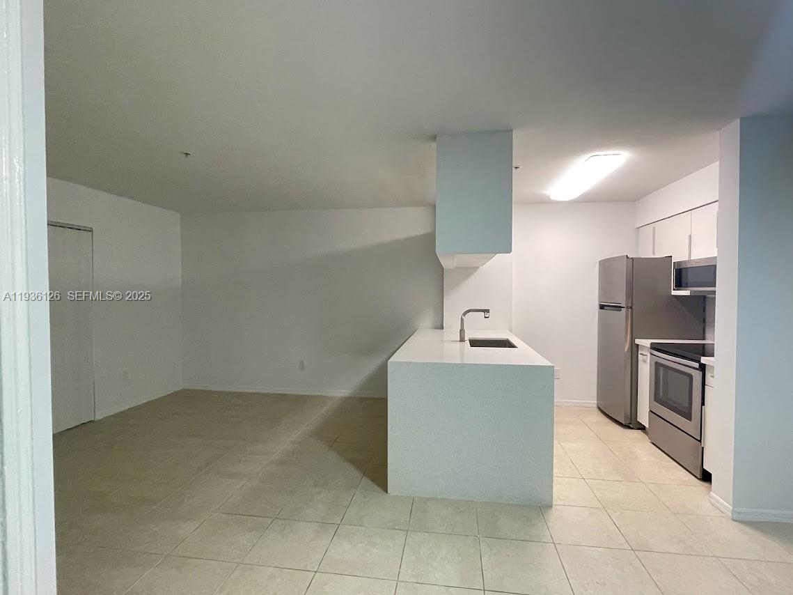 430 South Park Road, Unit 3305 Hollywood, FL 33021 - Photo 4 of 27 a kitchen with stainless steel appliances a refrigerator and a stove