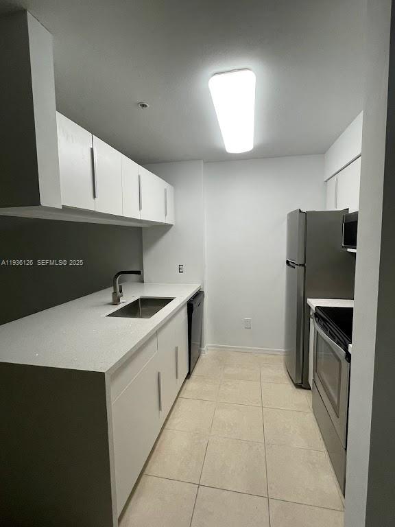 430 South Park Road, Unit 3305 Hollywood, FL 33021 - Photo 5 of 27 a kitchen with a sink a refrigerator and cabinets