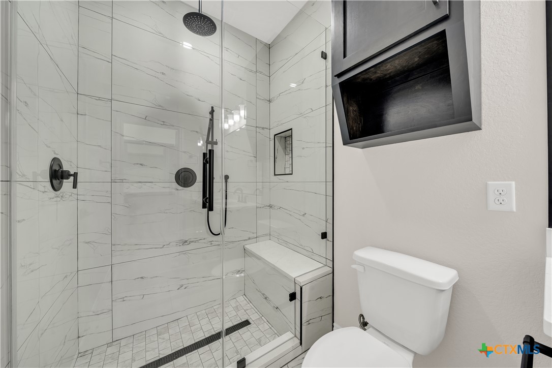 816 County Road, Unit 6723 Natalia, TX 78059 - Photo 12 of 19 a bathroom with a toilet sink a mirror and shower