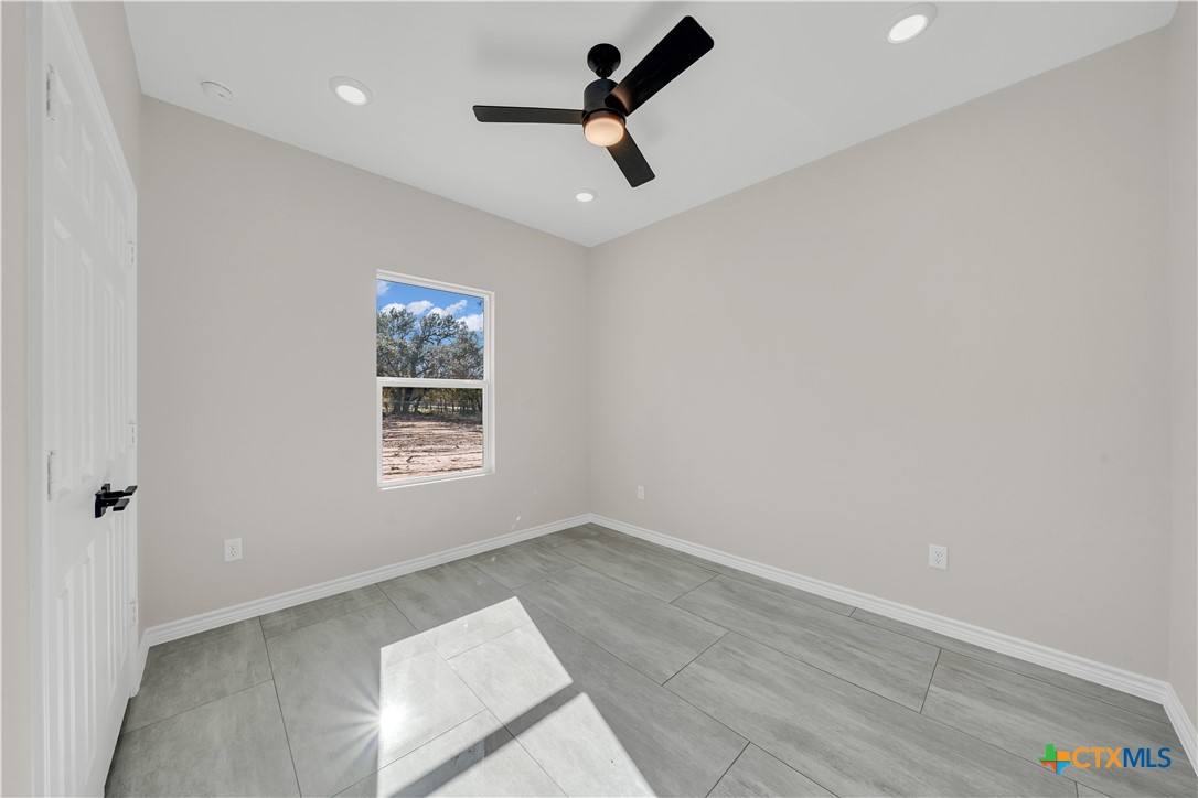 816 County Road, Unit 6723 Natalia, TX 78059 - Photo 15 of 19 wooden floor in an empty room with a window