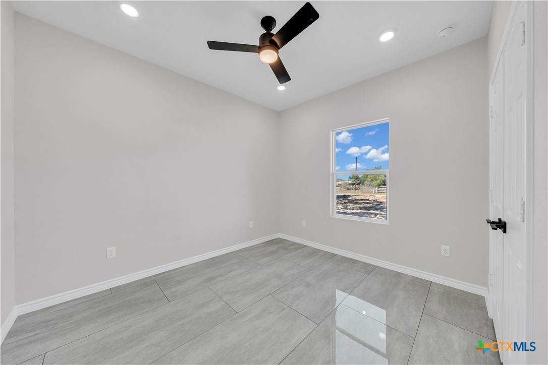 816 County Road, Unit 6723 Natalia, TX 78059 - Photo 17 of 19 wooden floor in an empty room with a window