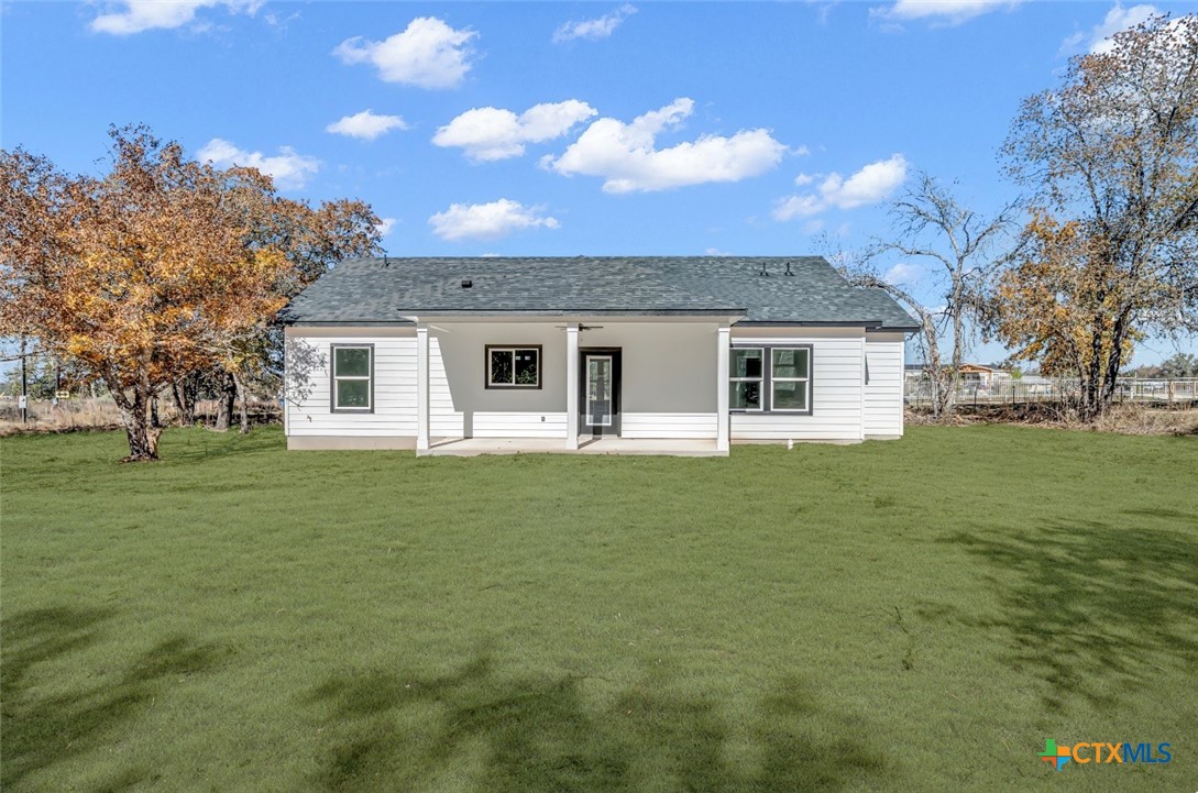 816 County Road, Unit 6723 Natalia, TX 78059 - Photo 18 of 19 a front view of a house with a garden