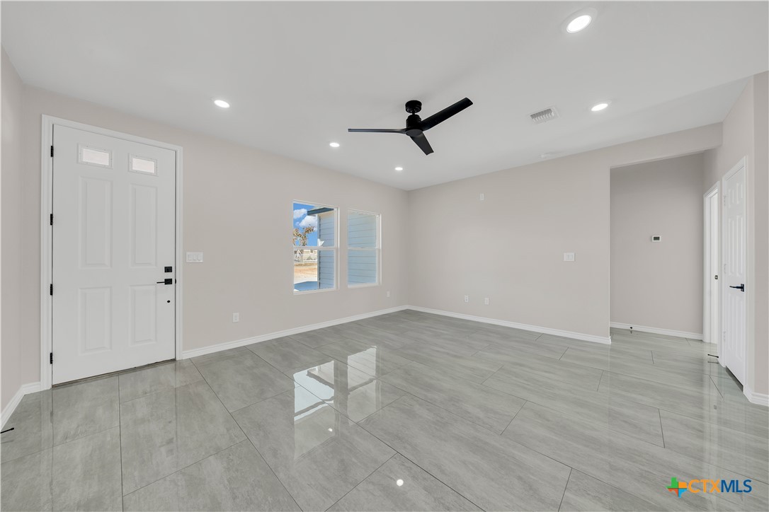 816 County Road, Unit 6723 Natalia, TX 78059 - Photo 3 of 19 wooden floor in an empty room with a window