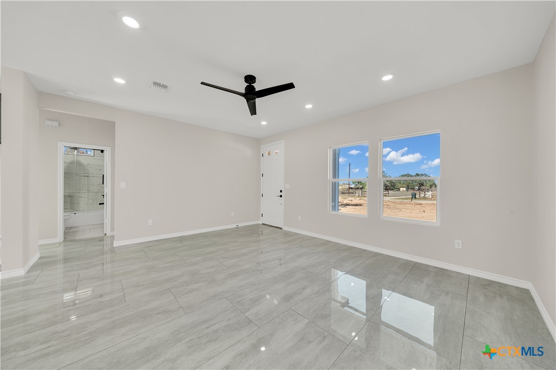816 County Road, Unit 6723 Natalia, TX 78059 - Photo 5 of 19 a view of a livingroom with a ceiling fan and window
