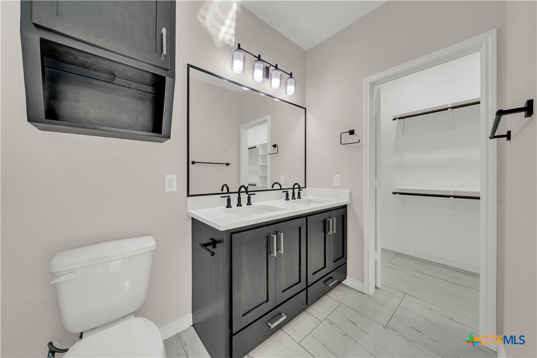 816 County Road, Unit 6723 Natalia, TX 78059 - Photo 9 of 19 a bathroom with a toilet sink and mirror