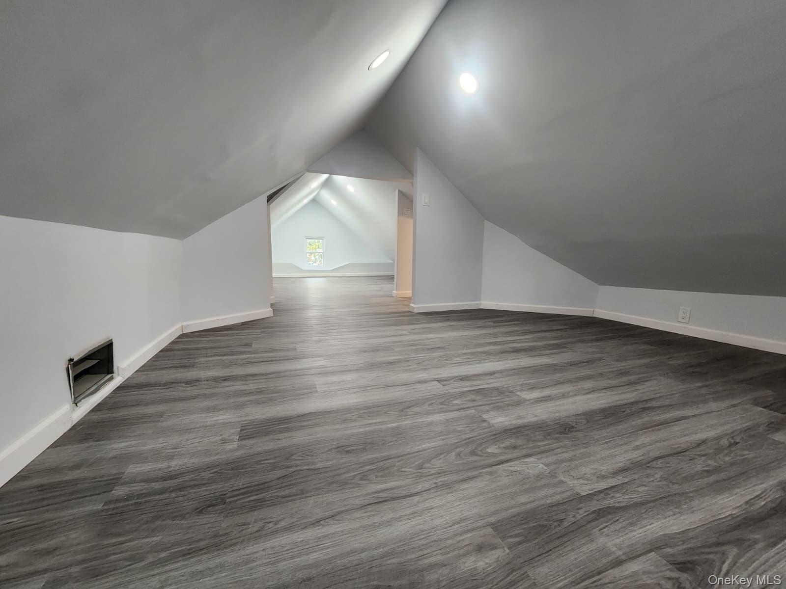 221-26 134th Road Queens, NY 11413 - Photo 30 of 30 an empty room with wooden floor and windows