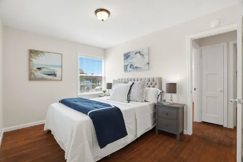 a bed room with a bed and a night stand