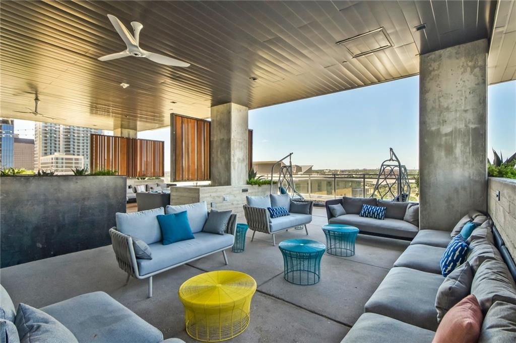 222 West Avenue, Unit 2207 Austin, TX 78701 - Photo 20 of 30 Expansive outdoor terrace featuring a textured ceiling with a modern ceiling fan, concrete support columns, and multiple seating areas