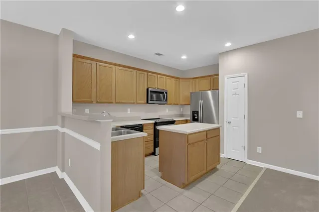 a kitchen with a stove a refrigerator and a sink