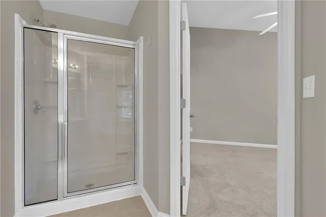 a bathroom with a glass shower door